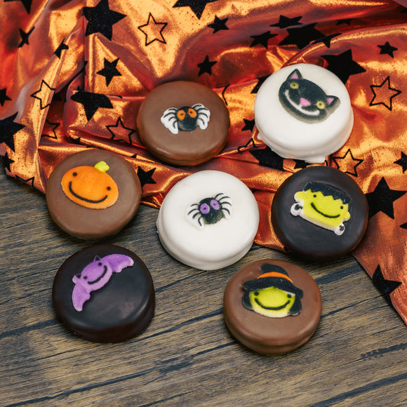 Oreo cookies covered in milk chocolate, dark chocolate or white coating. Each with a sugar Halloween decoration on top.