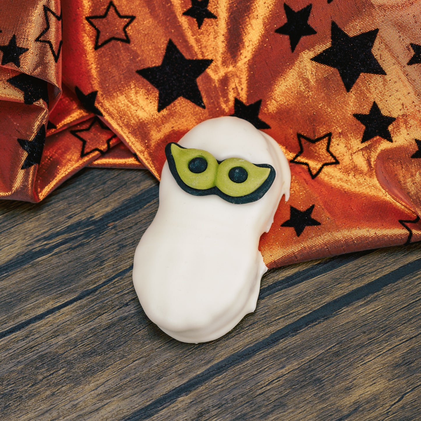 A Nutter Butter Cookie dipped in white coating with a set of sugar eyes