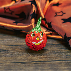 milk chocolate filled with peanut butter. wrapped in foil to look like a jack-o-lantern pumpkin