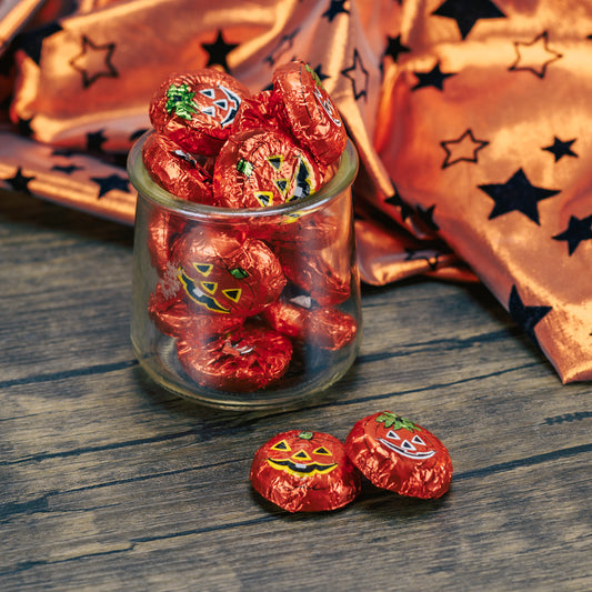 flat discs of milk chocolate wrapped in pumpkin face foil. Comes in half pound bags.