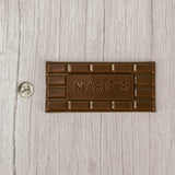 Milk chocolate molded into a bar that says "Marie's"