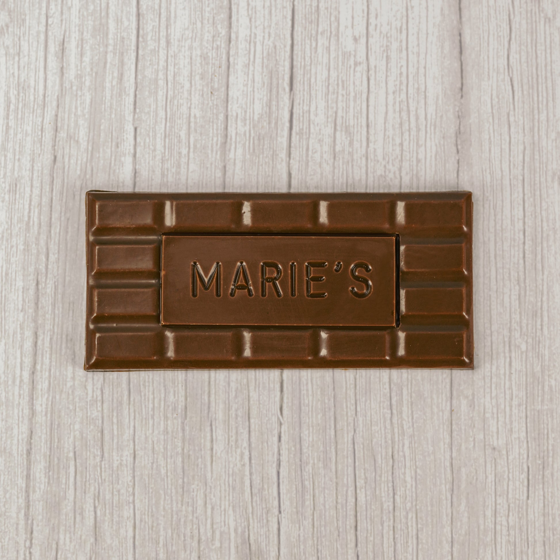 Milk chocolate molded into a bar that says "Marie's"
