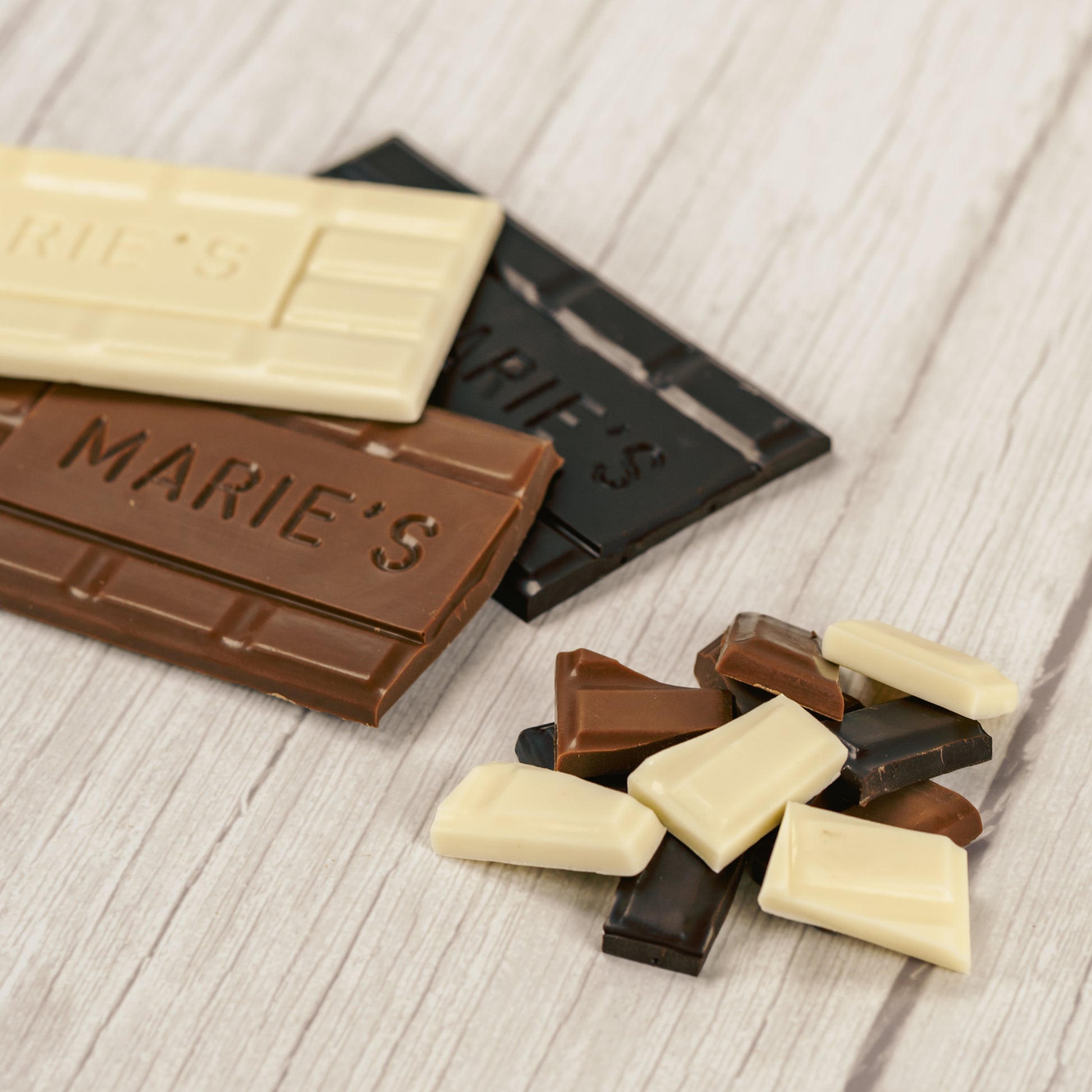 Milk chocolate, dark chocolate or white coating molded into a bar that says "Marie's"