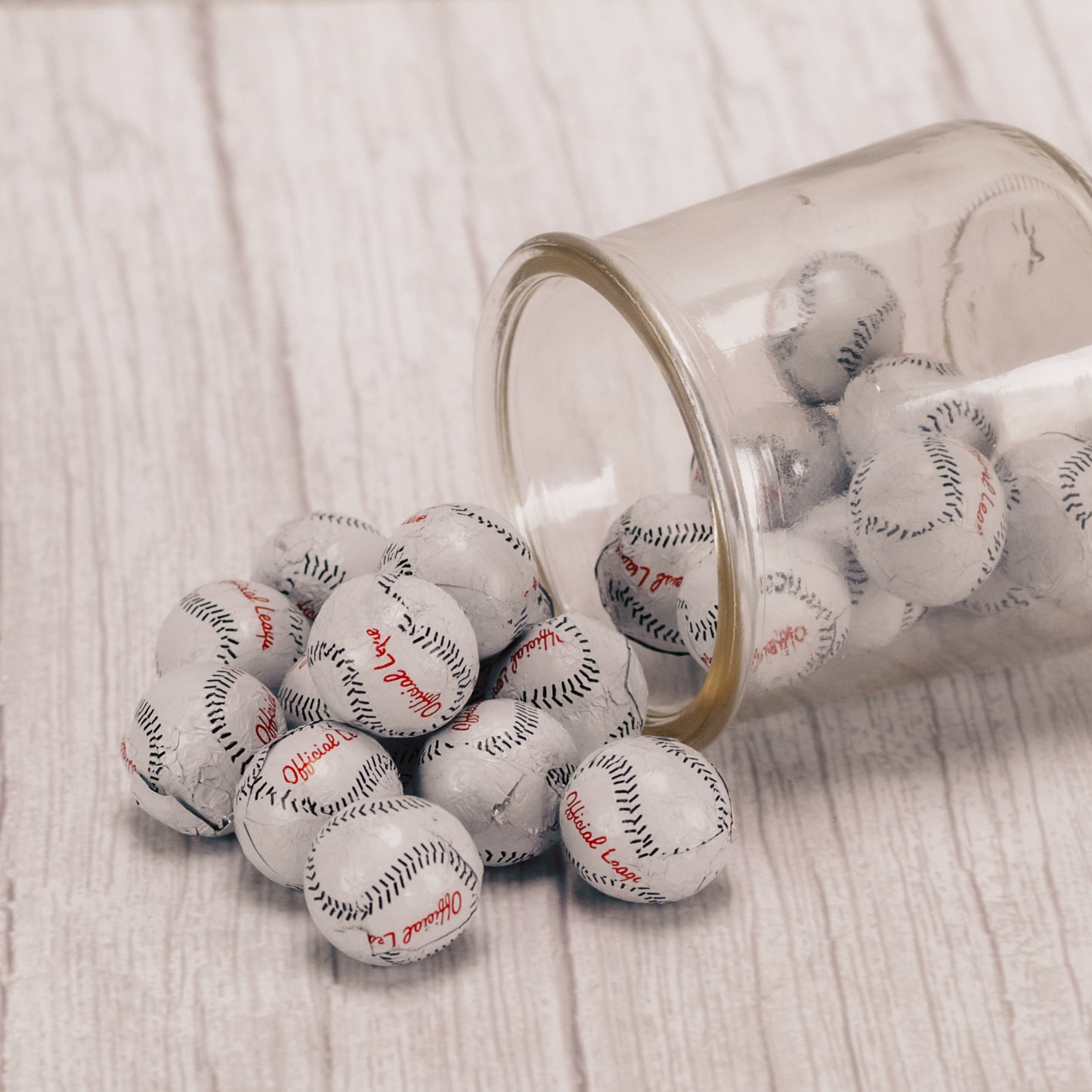 bite size milk chocolate balls wrapped in baseball foil in a half pound bag.