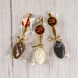 A plastic spoon dipped in milk chocolate, dark chocolate or white coating. Individually wrapped.