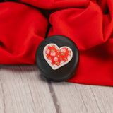 dark chocolate Oreo cookie with a sugar heart decoration on top