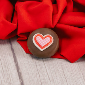 Milk or dark chocolate Oreo cookies with a sugar heart decoration on top