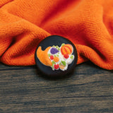 An Oreo cookie covered in milk or dark chocolate with a Thanksgiving turkey or cornucopia sugar decoration on top.