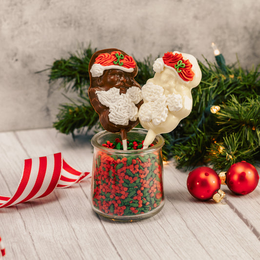 Santa on a stick in milk chocolate or white coating. Both have an icing beard and hat.