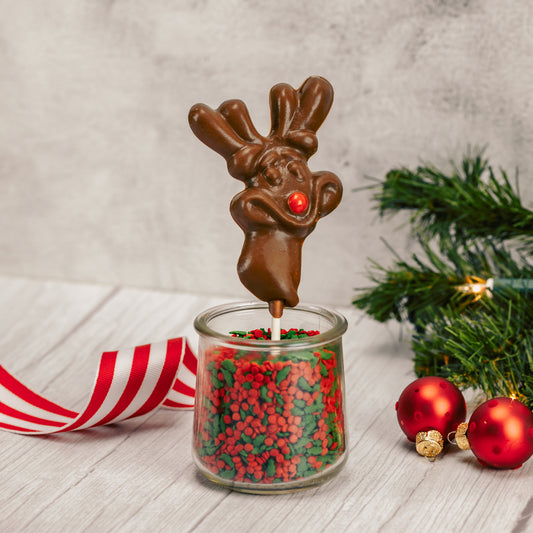 Milk chocolate Rudolph reindeer on a sucker stick. Red sixlet as its' nose