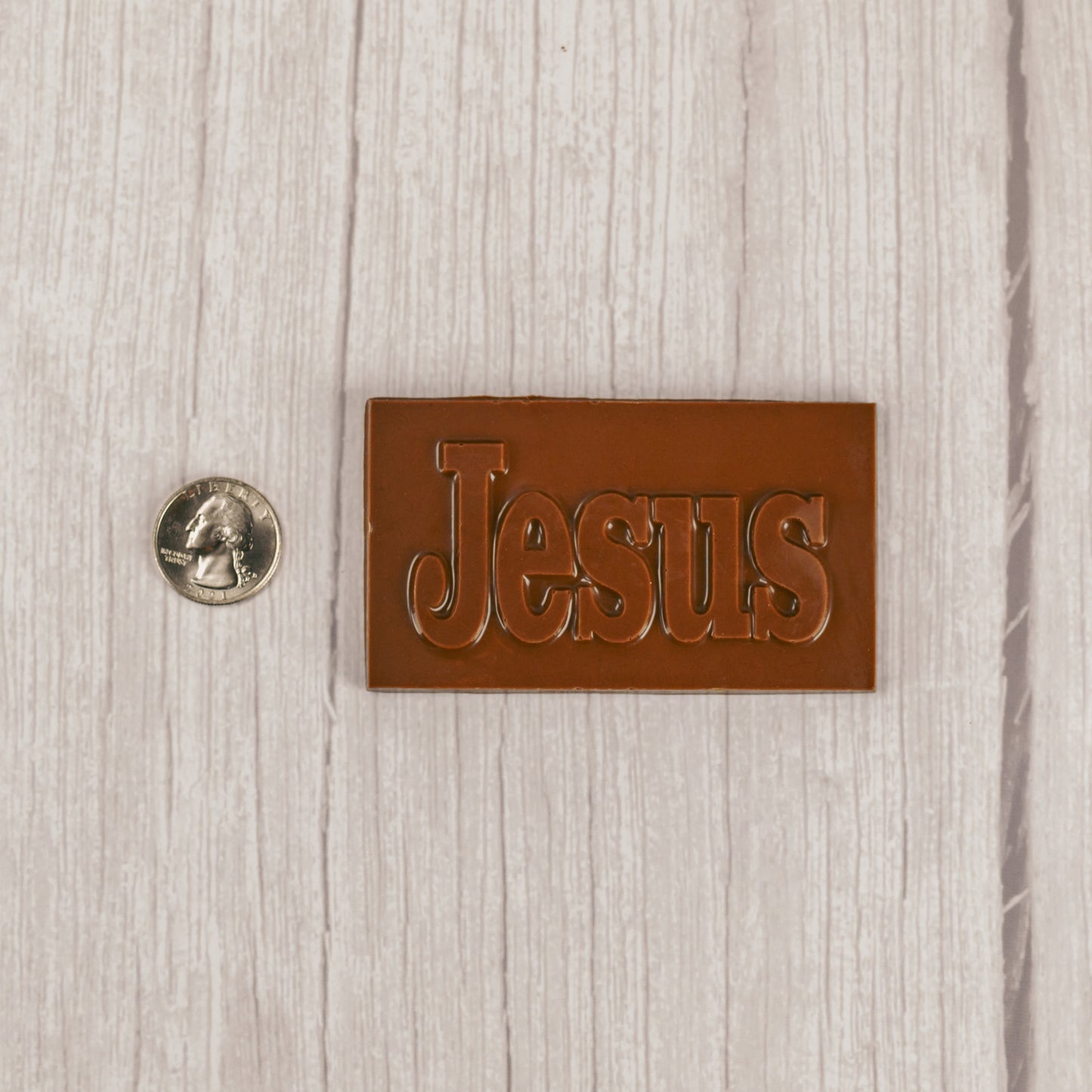 a small milk chocolate rectangle bar that reads "JESUS"