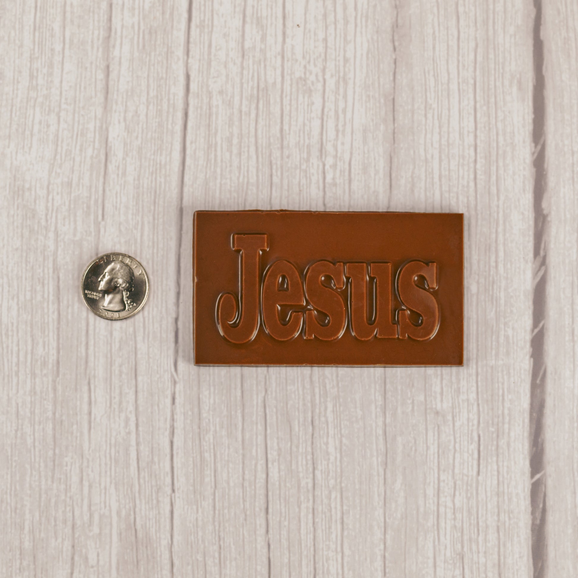a small milk chocolate rectangle bar that reads "JESUS"