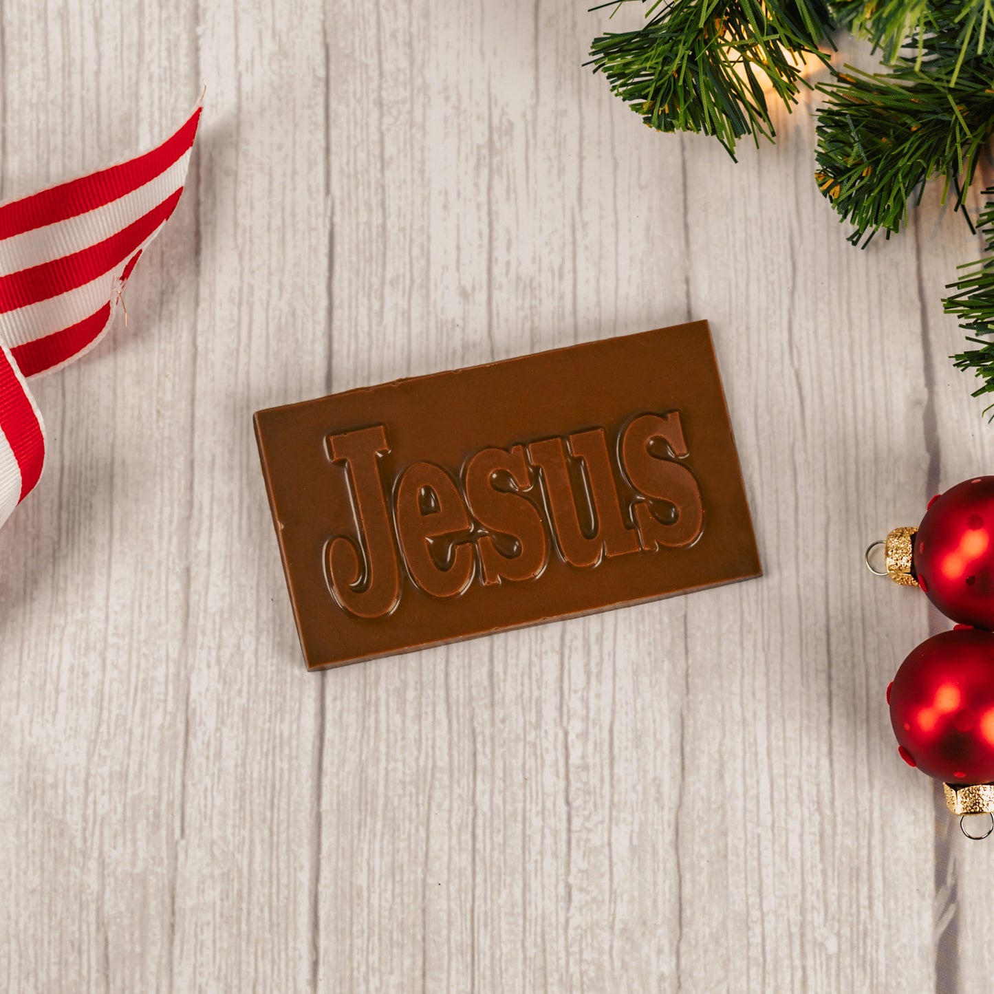 a small milk chocolate rectangle bar that reads "JESUS"