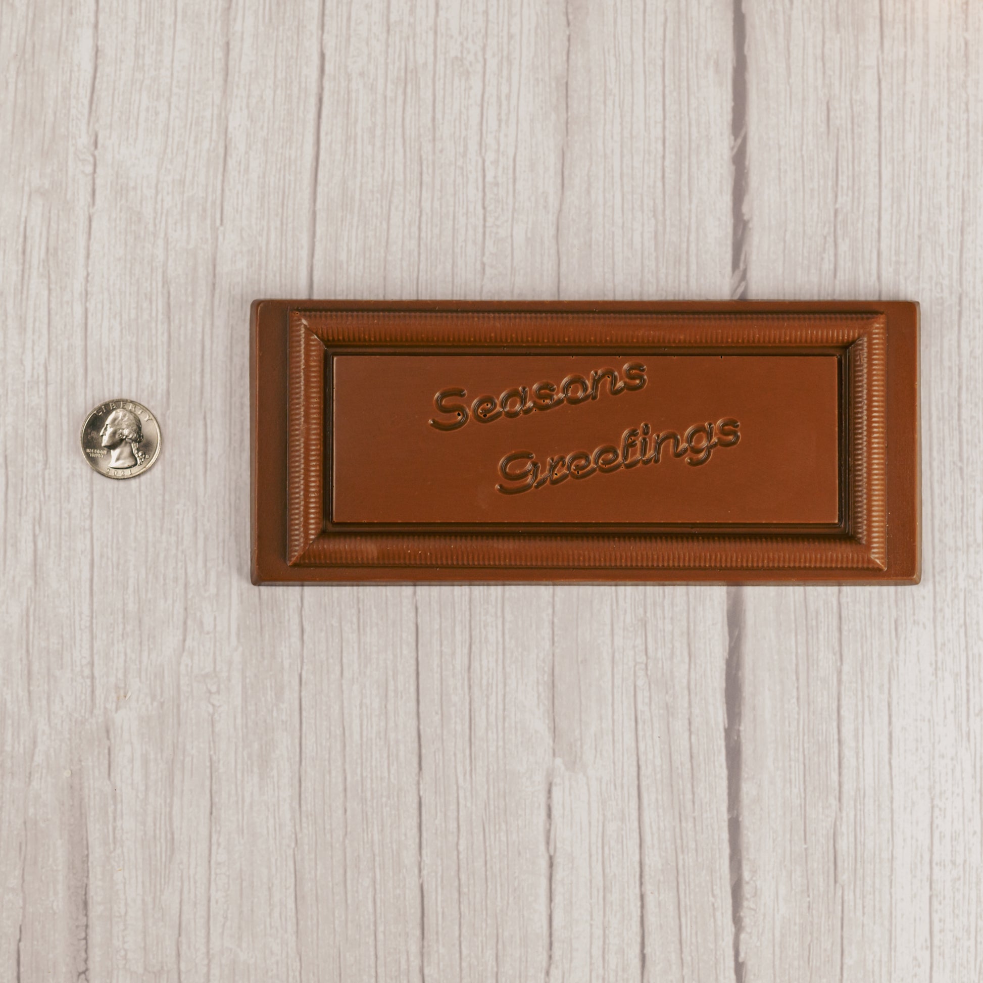 solid milk chocolate rectangle bar that reads "Season's Greetings"