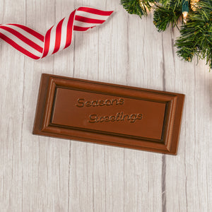 solid milk chocolate rectangle bar that reads "Season's Greetings"