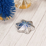 Silver and blue foil wrapped milk chocolate snowflake.