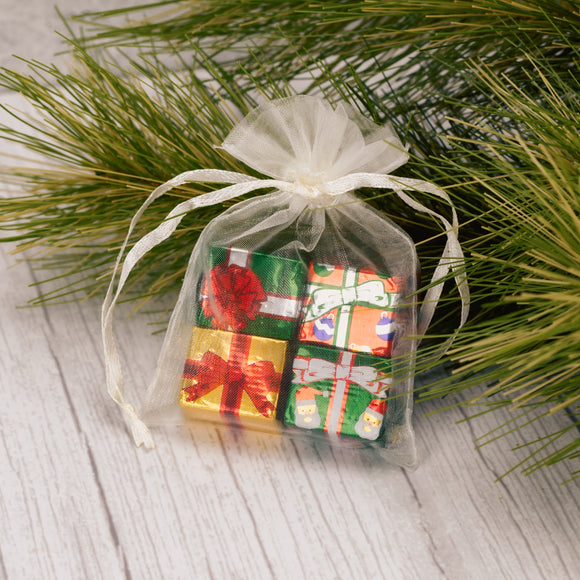 a small gauzy pouch filled with four milk chocolate presents. Assorted colors of pouches; red, green and white.
