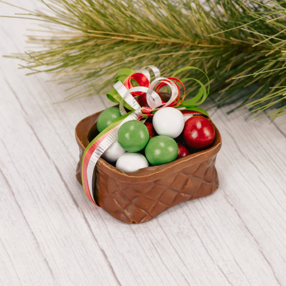 A chocolate basket filled with either Christmas Dutch Mints. Tied with a curly ribbon bow