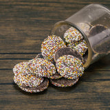 Flat milk chocolate wafers covered in rainbow nonpareils in half pound bags. 