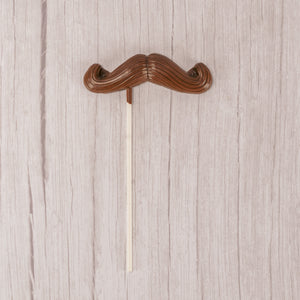 Milk chocolate mustache on a large sucker stick.