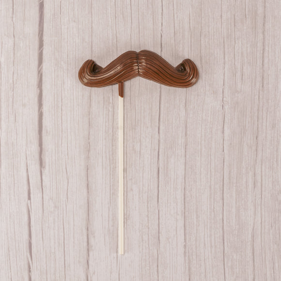 Milk chocolate mustache on a large sucker stick.