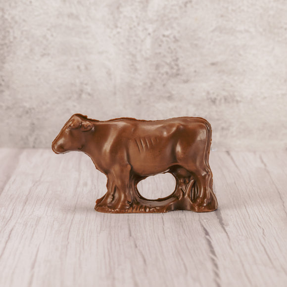 a standing solid milk chocolate cow