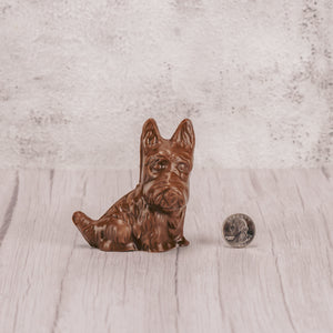 A scottie dog in milk chocolate, dark chocolate or white coating.