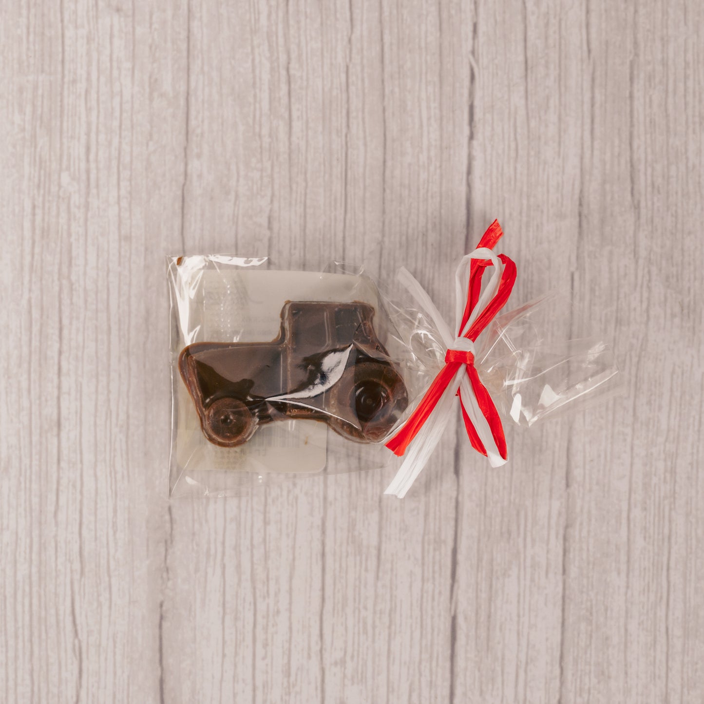 a small milk chocolate tractor. Individually packaged and tied with red and white ribbon.