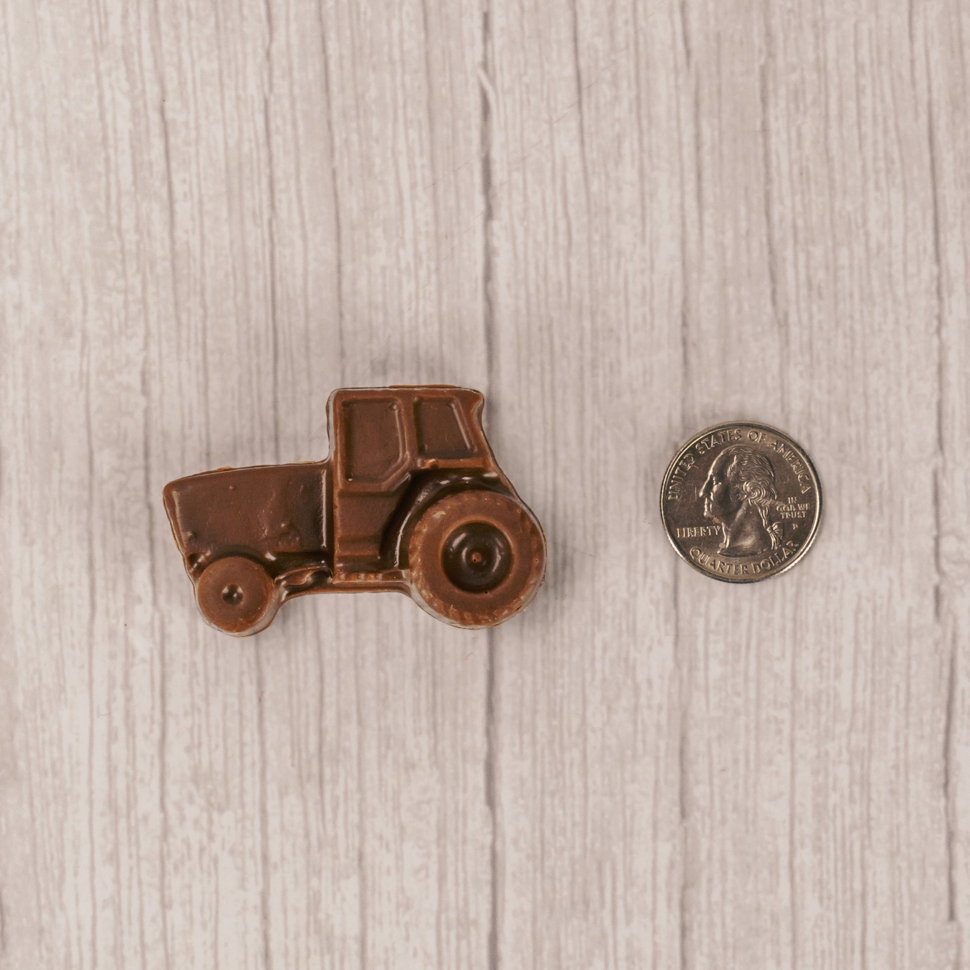 a small milk chocolate tractor. Individually packaged and tied with green and yellow ribbon or red and white ribbon.