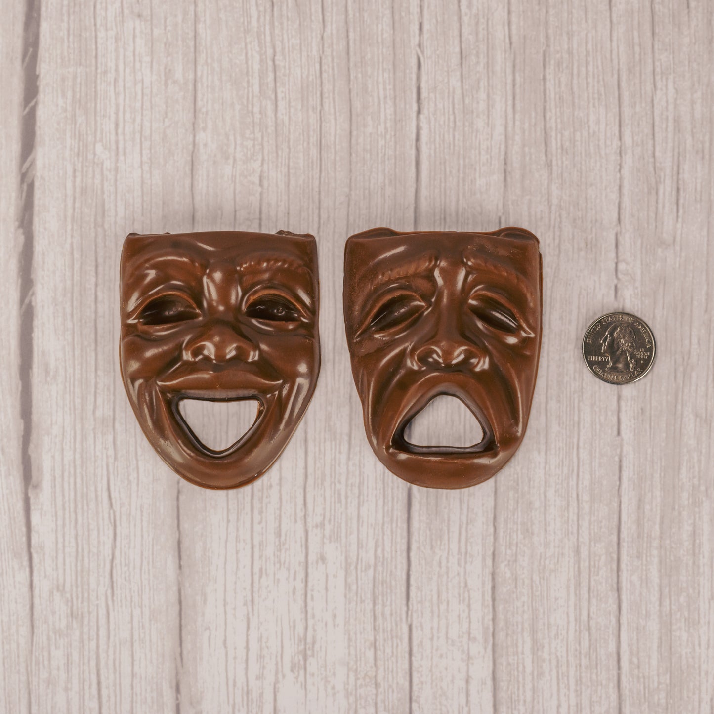 a drama mask smiling or frowning in milk chocolate.