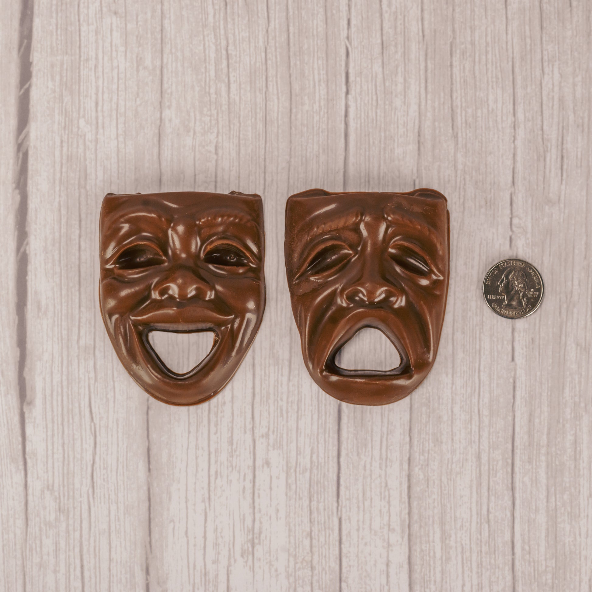 a drama mask smiling or frowning in milk chocolate.