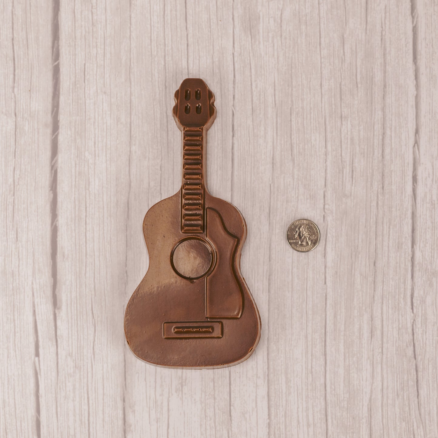 milk chocolate guitar placed in a box