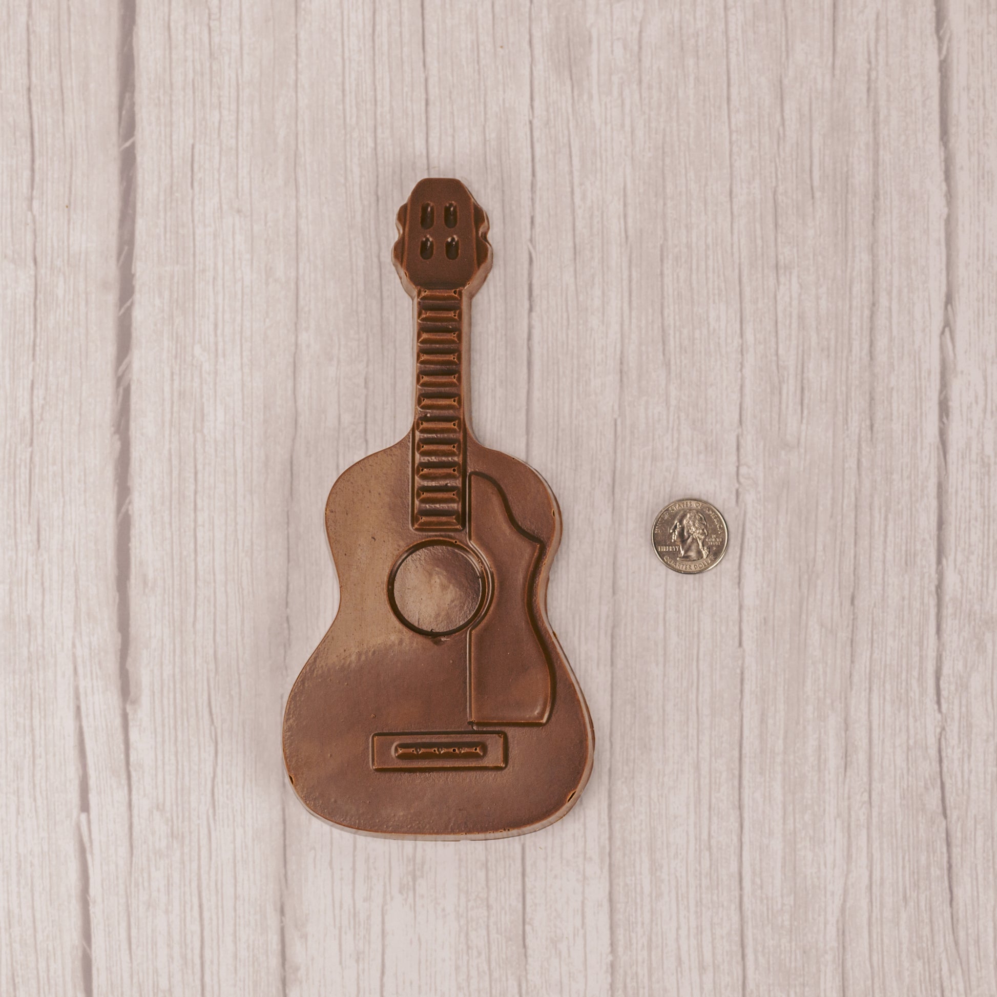 milk chocolate guitar placed in a box