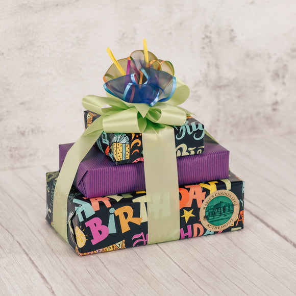 a lovely bundle of happiness, perfect for any birthday celebration. A gift stack of delicious candies like: sampler, 1/2 lb. milk chocolate malt balls, 1/2 lb. milk chocolate rosebuds, dark graham cracker and milk oreo. Wrapped festively in birthday paper and tied with a lovely handmade bow. 