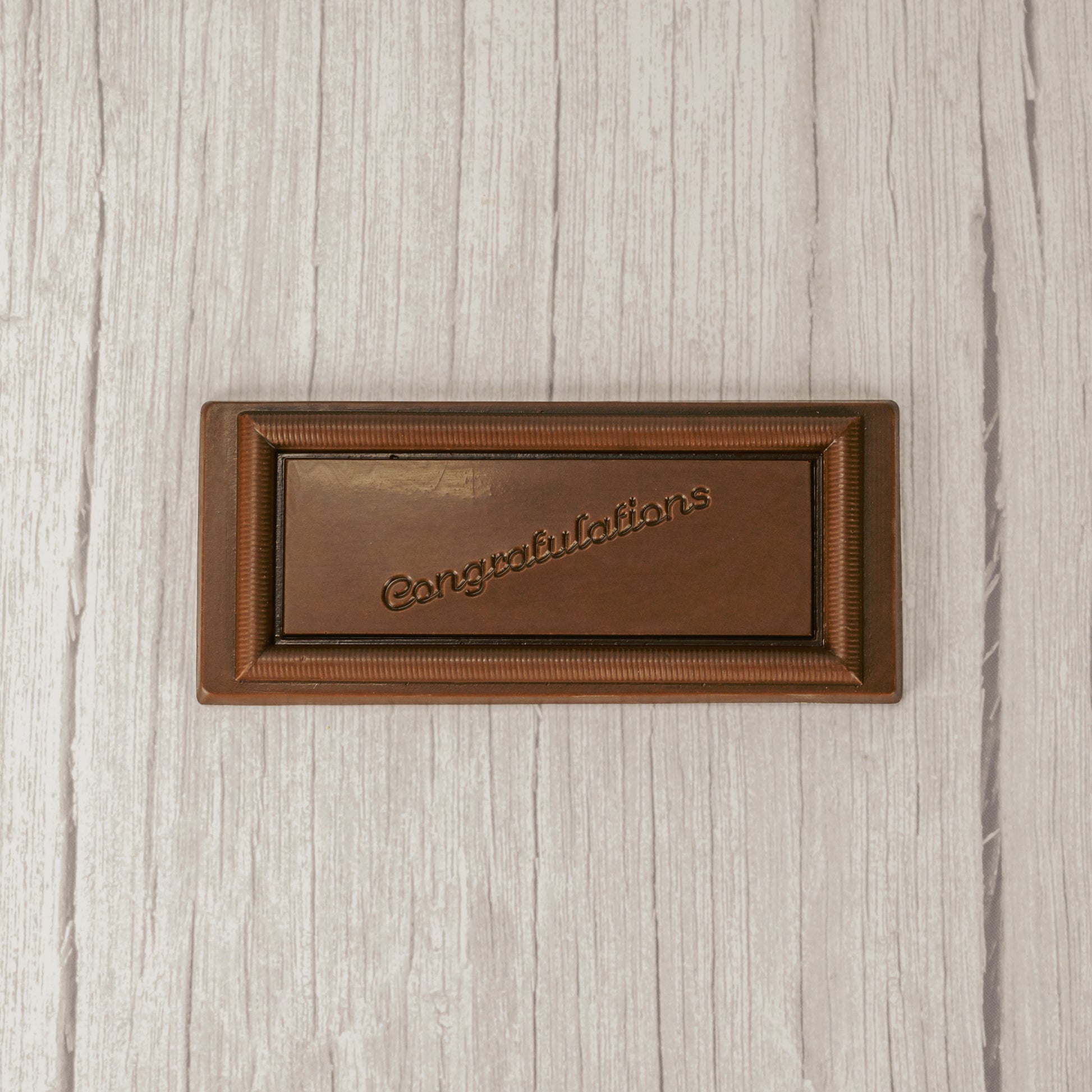 a rectangle solid milk chocolate bar that reads "Congratulations"