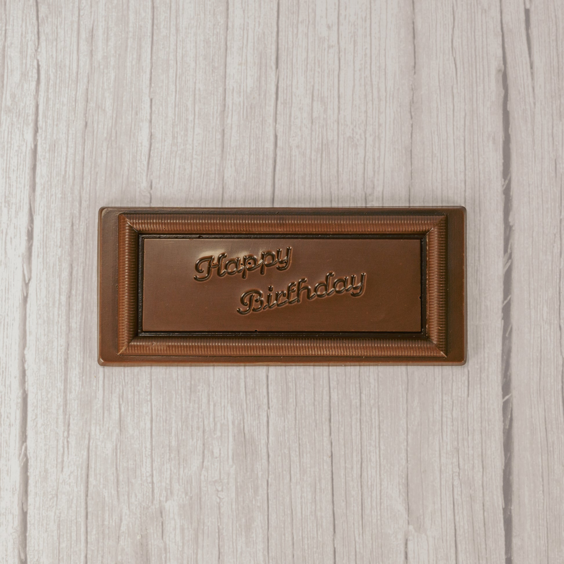 a rectangle solid milk chocolate bar that reads "Happy Birthday"