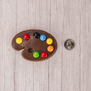 A painter's palette in milk chocolate or white coating (tastes like white chocolate)with M&Ms representing paint colors.