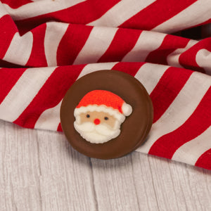 Oreo cookies covered in smooth milk chocolate or rich chocolate and decorated with a sugar Christmas decoration