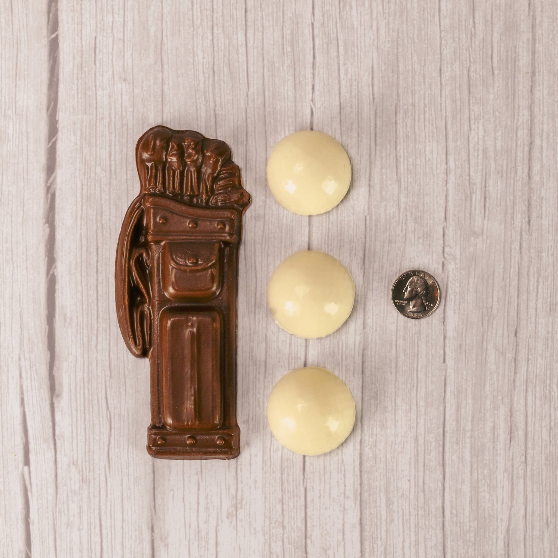 white coating golf balls and milk chocolate golf bag packaged together in a box.