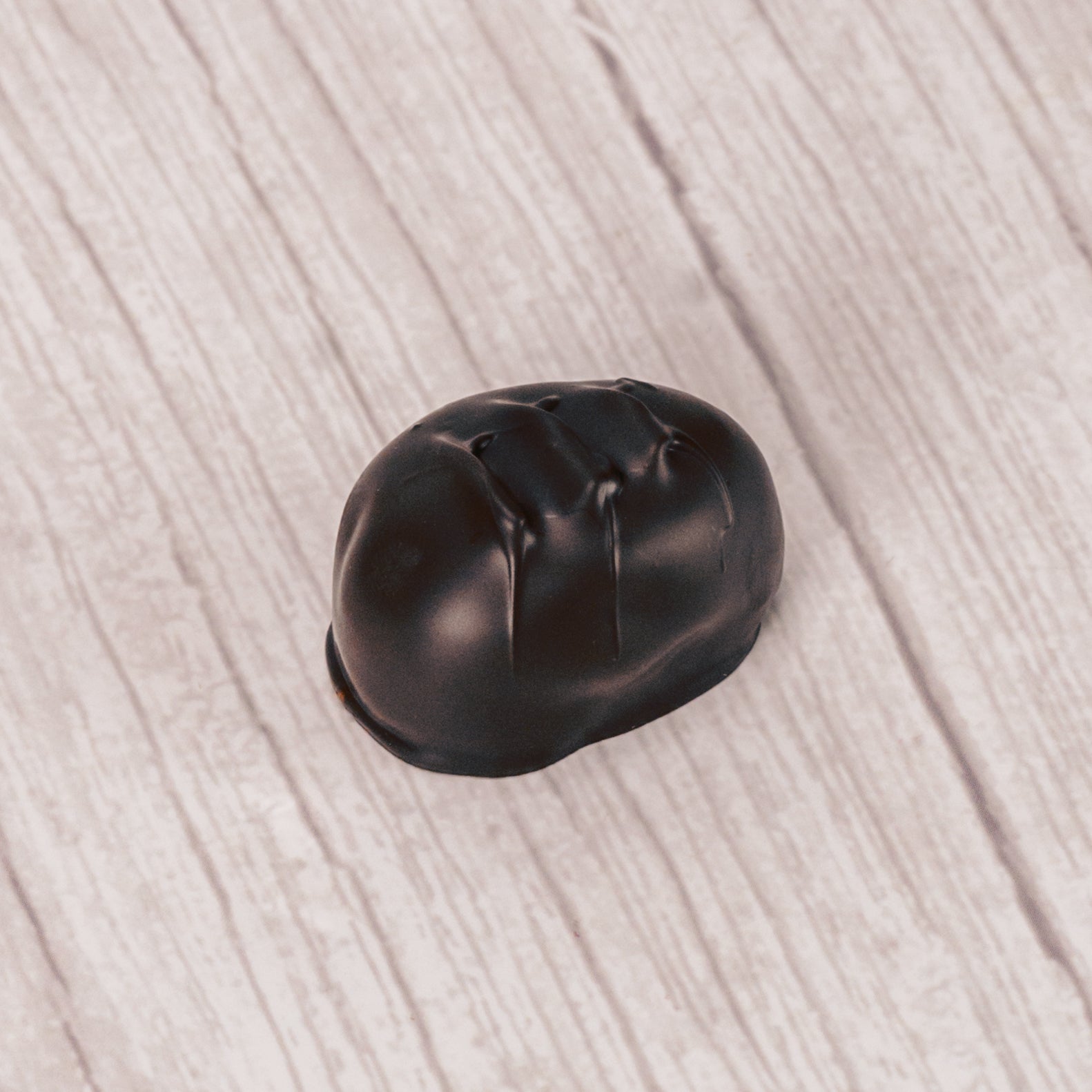 coconut cream with shreds of coconut pieces covered in rich dark chocolate in a pound box.