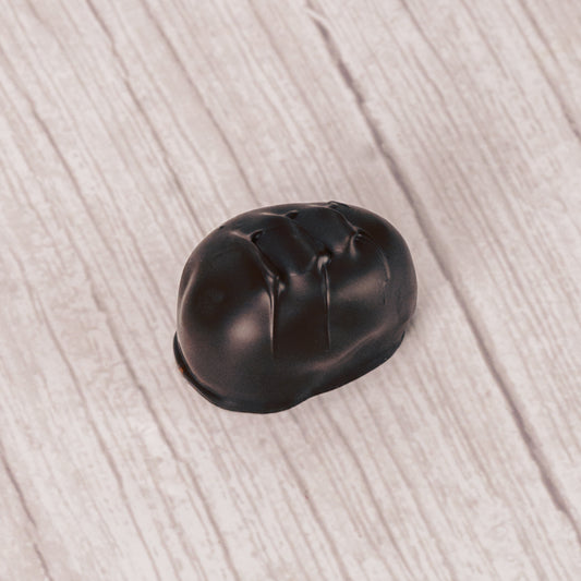 coconut cream with shreds of coconut pieces covered in rich dark chocolate in a pound box.