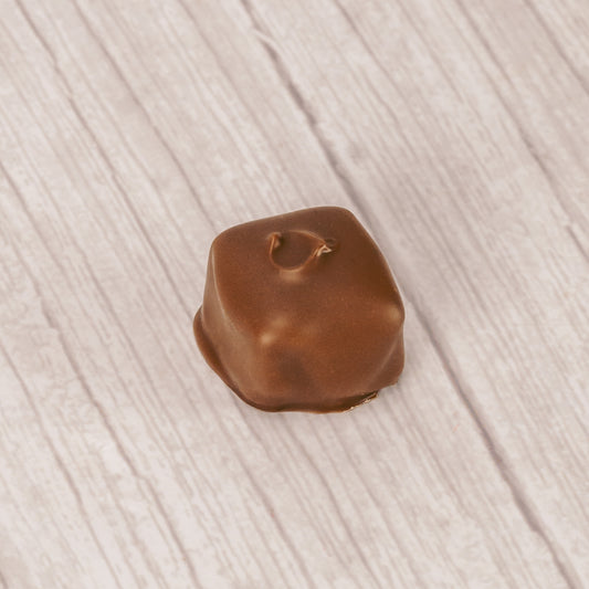 Smooth chocolate center covered in milk chocolate in a pound box.