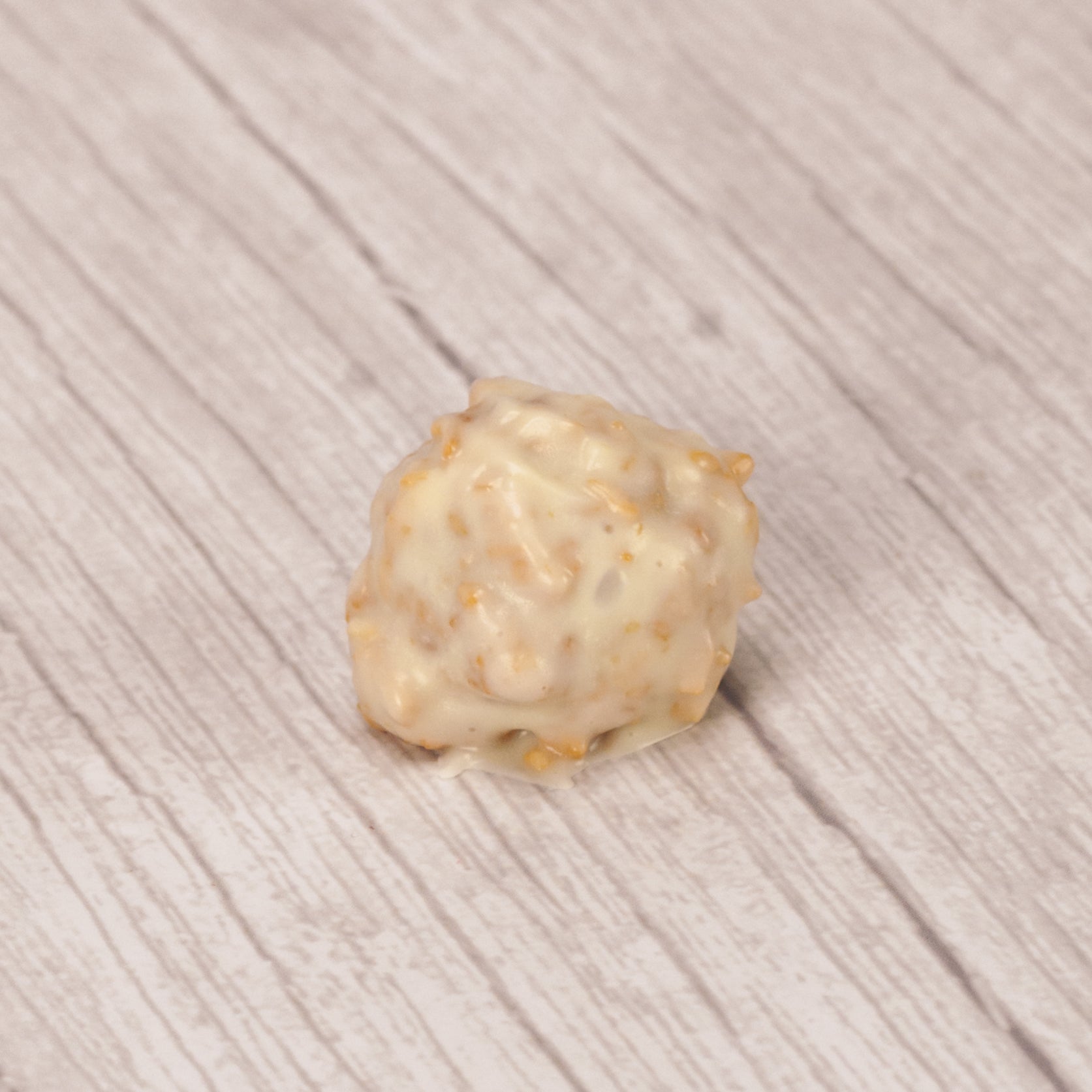 a pound of fudgy chocolate centers dipped in white coating mixed with toasted coconut.