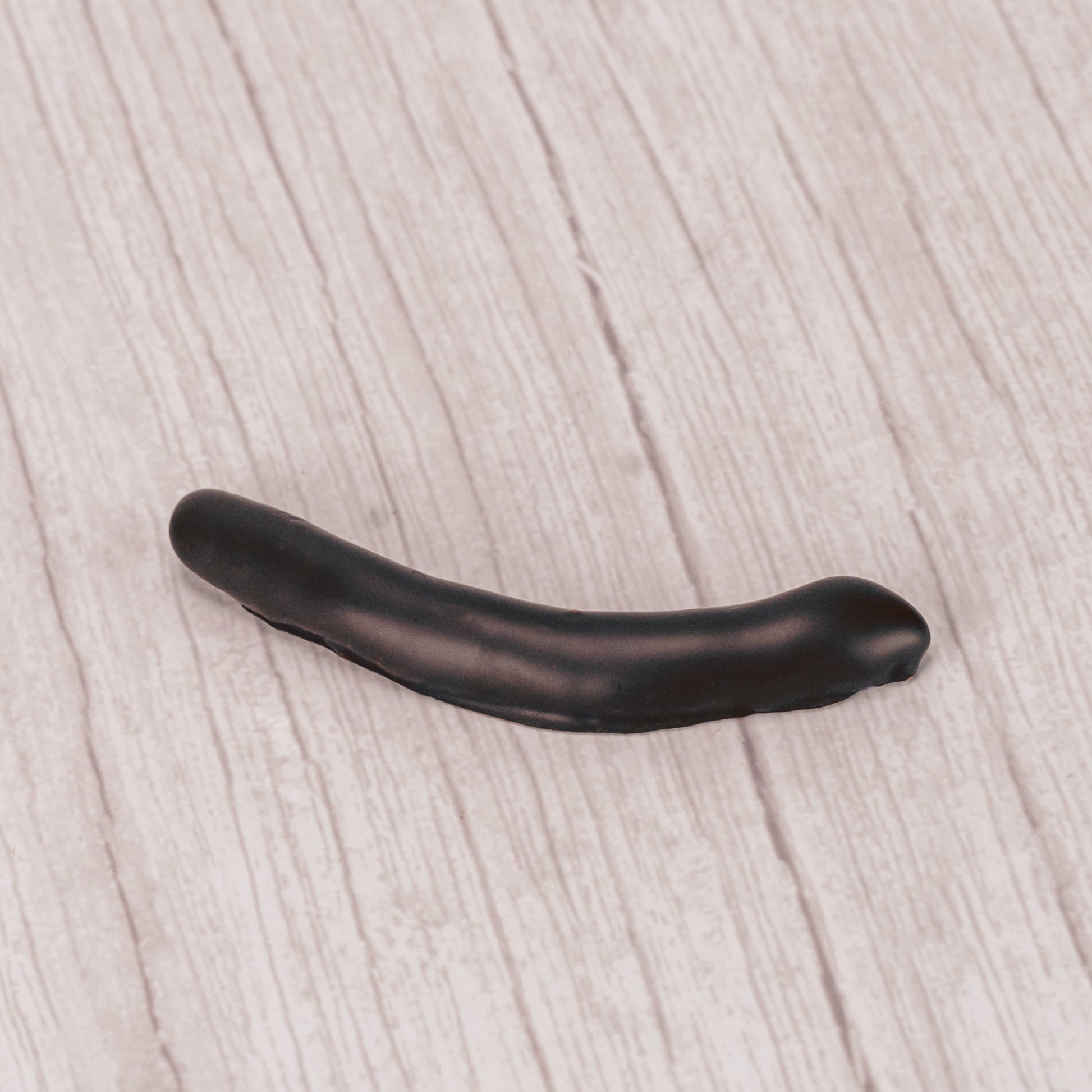 candied orange peel strips covered in rich dark chocolate in a pound box.