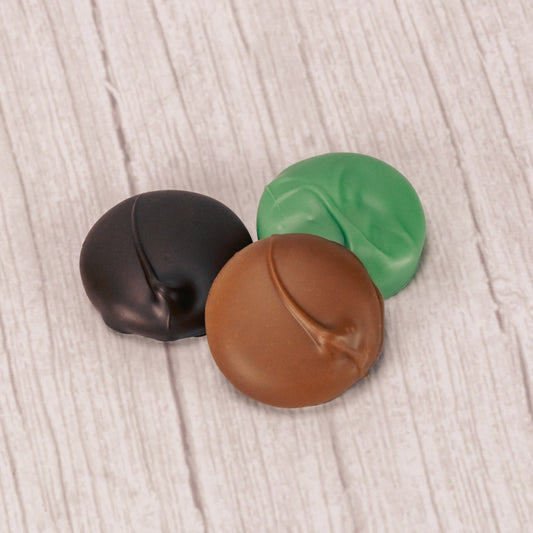 white peppermint cream center covered in rich dark chocolate, smooth milk chocolate or sweet green coating (tastes like white chocolate) in a pound box.