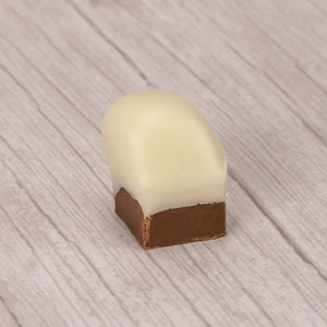 Silky chocolate bottom with a dollop of caramel and dipped in white coating. Looks like a smoke stack chimeny with snow. Packaged in a clear rectangle tube. About a half pound