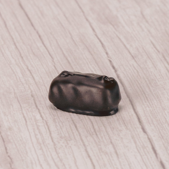 Raspberry jelly center dipped in dark chocolate in a pound box.