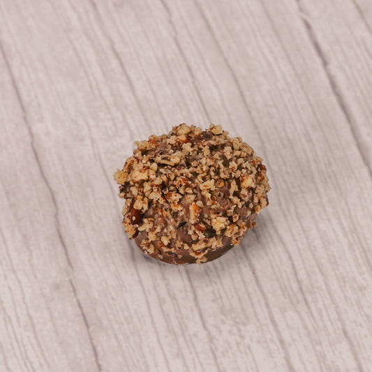 a pound box of rich vanilla cream centers covered in milk chocolate and topped with crushed pecans