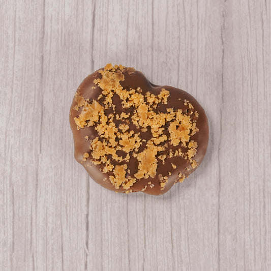 a jumbo pretzel filled with caramel in its' three holes, covered in smooth milk chocolate and sprinkled with crushed butter crunch crumbs.
