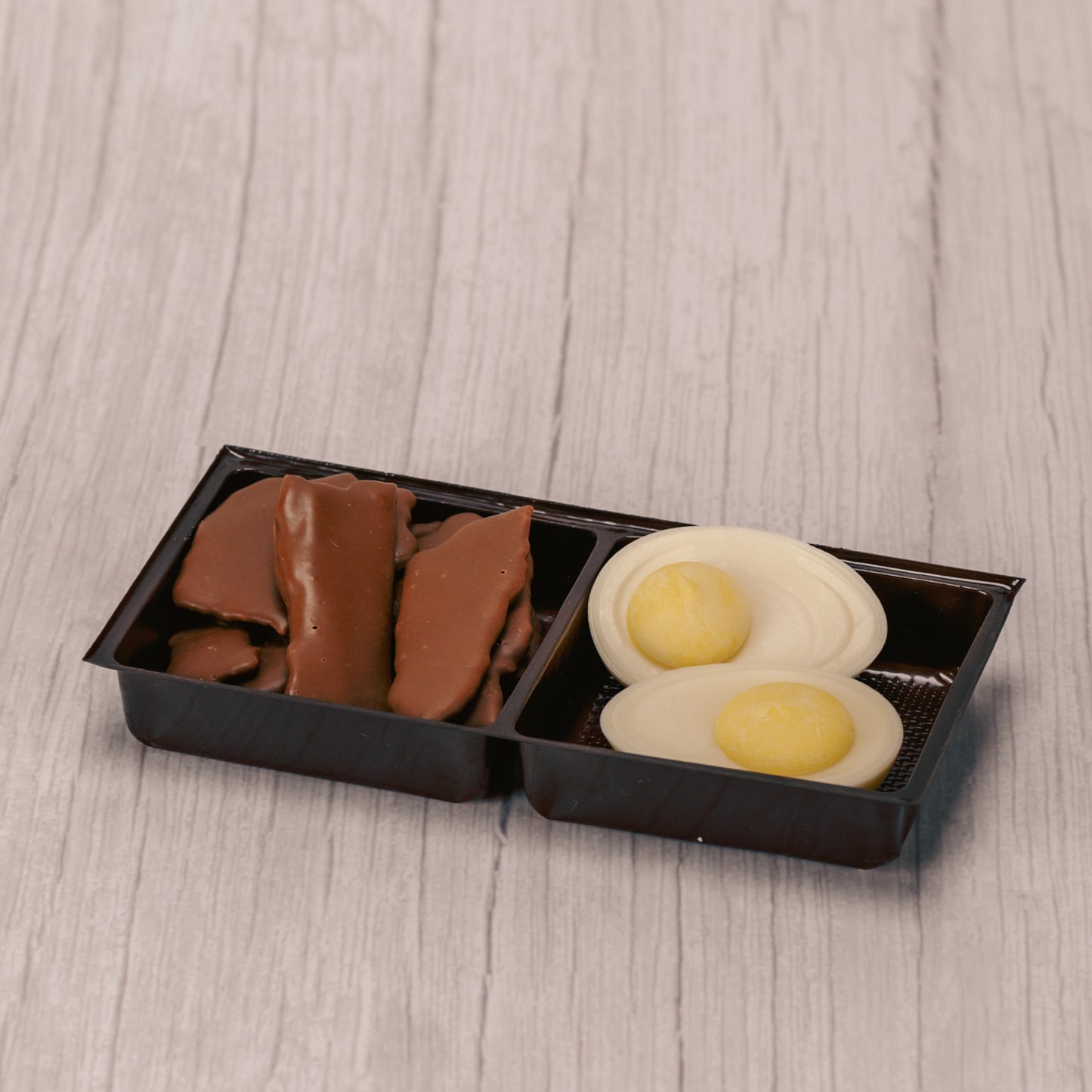 Milk chocolate covered bacon (real bacon- crispy!) and white and yellow coating deviled eggs packaged together for breakfast!!!